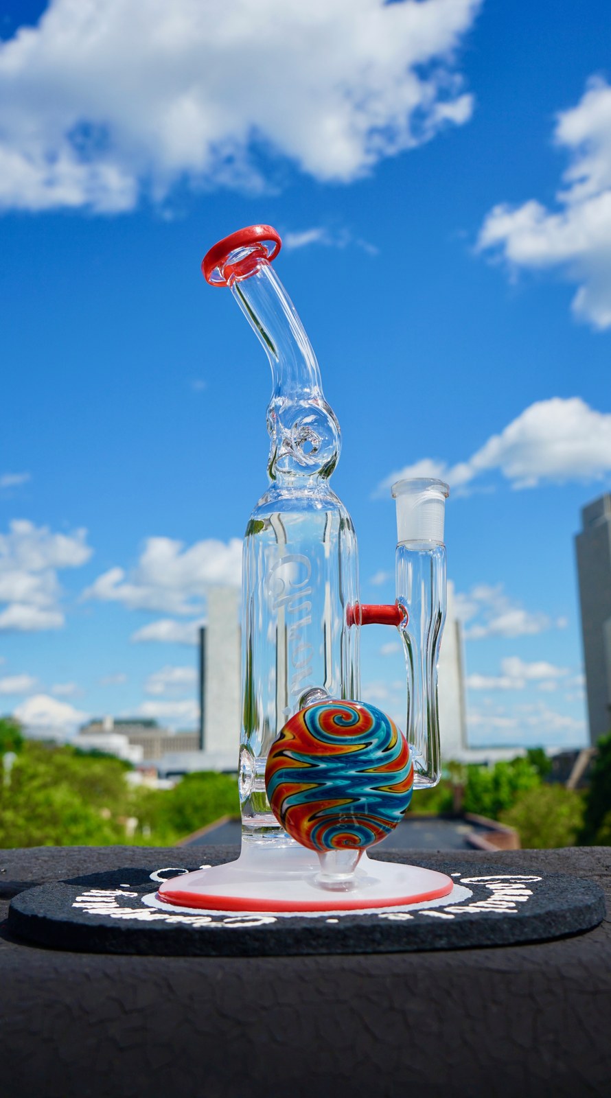 Chronic Glass cylinder dab rig photographed against a blue sky.
