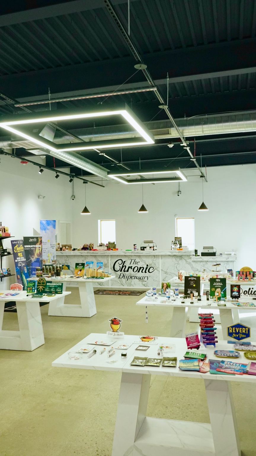 Modern cannabis dispensary interior with display cases and packaged products.